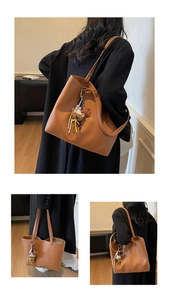 Detailed view of caramel leather tote bag featuring cute bear and star charms decoration