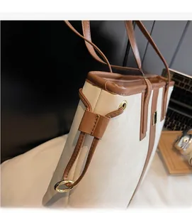 Détail du cabas en cuir grainé avec bordures marron et garnitures dorées