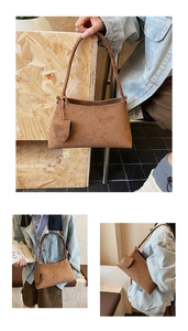 Detailed view of brown faux suede hobo bag with matching small pendant and long handle