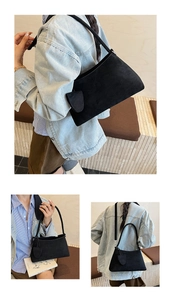 Detailed view of black suede hobo bag texture and adjustable shoulder strap detail