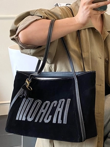 Black large capacity tote bag with MOACAI embroidery and tassel detail for women