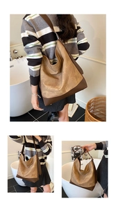 Detail of a large capacity vintage hobo bag in contrast brown colors with soft matte texture