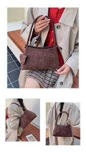 Detail of a brown suede hobo bag featuring knotted shoulder strap and matching small pouch