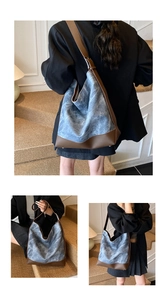 Detail of blue marble texture tote bag with brown leather strap and contrast stitching