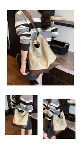Detail view of large retro tote bag with cream gold PU and dark brown leather straps