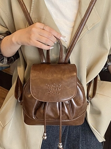 Fashionable dark brown faux leather mini backpack with drawstring and letter embossing