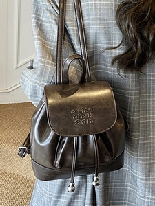 Retro brown faux leather backpack with drawstring closure and metal ball charms