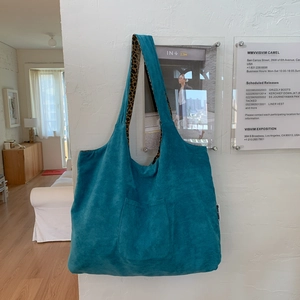 Detail of light blue corduroy tote bag featuring a stylish leopard print lining
