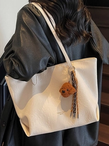 Chic beige PU leather tote bag with pleated texture and plush puppy charm for women