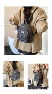 Detail view of mini checkered backpack with silver zippers and black shoulder straps