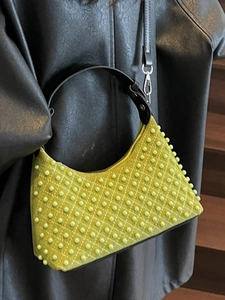 Chic turquoise quilted rivet handbag with pearl accents and black shoulder strap