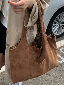 Brown faux suede tote bag with leopard lining and front pocket for casual commute