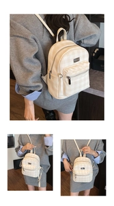 Detail of a chic beige gingham mini backpack with front zipper pocket and metal logo plate