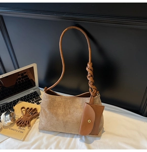 Dettaglio della borsa tote in pelle scamosciata marrone con nodo in pelle e mini pochette
