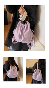 Detail of lavender drawstring backpack with vibrant yellow handle and textured fabric