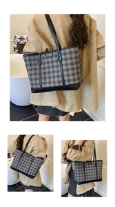 Detailed macro view of the black checkered tote bag with leather straps and gold branding