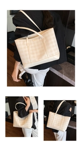 Detail of minimalist beige plaid tote bag showing texture and leather brand label