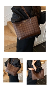 Detailed view of large checkered tote bag with brown leather straps and metal brand plate
