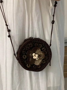 Bohemian handmade woven mini round crossbody bag with brown wood beads and floral decor