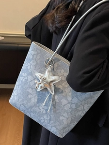 Floral light blue tote bag with silver star and balloon dog charms for casual commuting