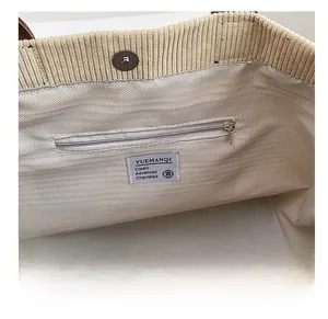 Detail of corduroy tote bag interior with magnetic closure and zippered inner pocket