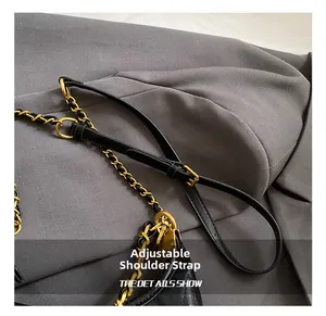 Close-up of adjustable shoulder strap with black leather and gold chain detail