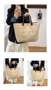 Detail of beige corduroy tote bag with TOTE BAG print and brown leather handles
