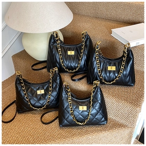 Detail showing four styles of black quilted tote bags with gold chains and turn-lock closure