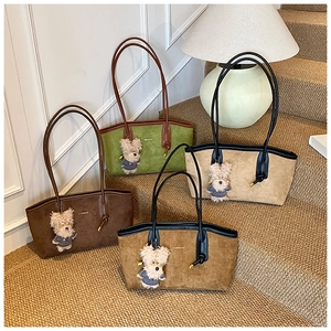 Detail view of four large capacity suede tote bags in various colors on steps