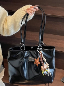 Large black glossy faux leather tote bag with silver logo and bohemian star keychain