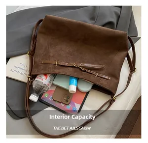 Detailed view of the large capacity dark brown suede tote bag with daily essentials inside