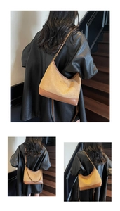 Detail of hobo shoulder bag featuring suede texture and vintage chain strap