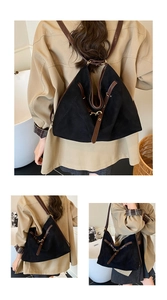 Detailed view of the vintage hobo bag showing the black suede texture and brown leather strap