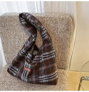 Close-up of brown plaid hobo bag in tweed fabric with Star-picking leather patch