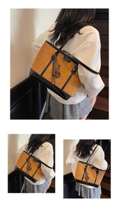 Detail of minimalist ginger yellow suede tote bag with black leather straps and stitching