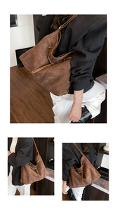 Detailed macro view of brown suede tote bag with long tassels and metal ring buckle