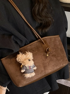 Brown suede tote bag with teddy bear charm and slender straps for casual office commute