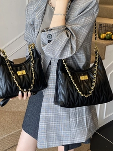 Classic black quilted leather tote bag with gold chain strap and turn-lock closure