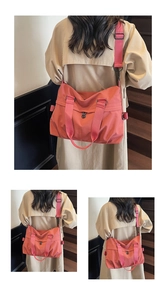 Detailed view of coral pink nylon tote bag with wide strap for casual commute