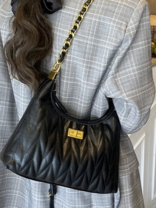 Chic black quilted hobo shoulder bag with wavy pleats and gold chain for women
