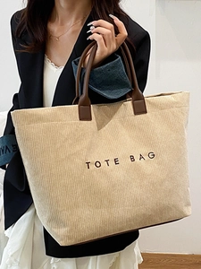 Minimalist corduroy tote bag with leather handles and TOTE BAG lettering for commute