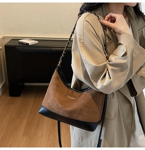 Retro brown suede underarm bag with black leather trim and chain strap shown on model