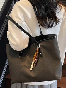 Large olive canvas tote bag with black leather straps and designer beaded charm detail