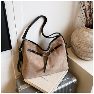 Detail view of the vintage matte leather tote bag featuring gold hardware and black strap