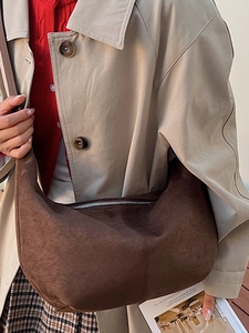 Large dark brown suede half-moon crossbody bag in a minimalist vintage style for women
