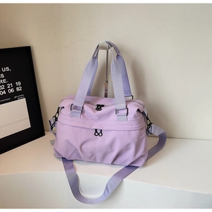 Detail view of lilac travel gym bag with black hardware and adjustable shoulder strap