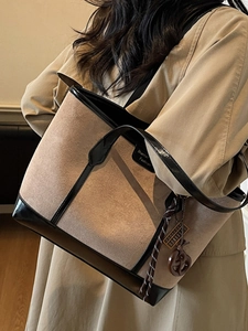 Minimalist large-capacity beige canvas tote bag with black leather trim and woven charm