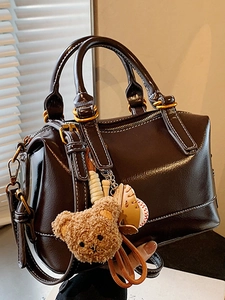 Premium dark brown oil wax leather pillow bag with cute bear charm and gold hardware