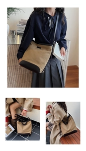 Detailed views of a vintage canvas bucket bag with leather patchwork and slim strap