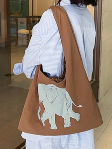 Brown canvas shoulder bag with large elephant print and wide straps for daily use